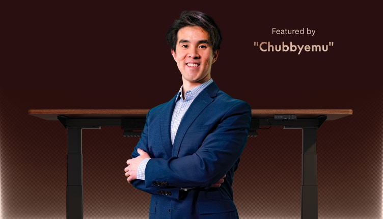 Standing desk with dark wooden tabletop and black frame featured alongside a person in a blue suit, highlighted by "Chubbyemu".